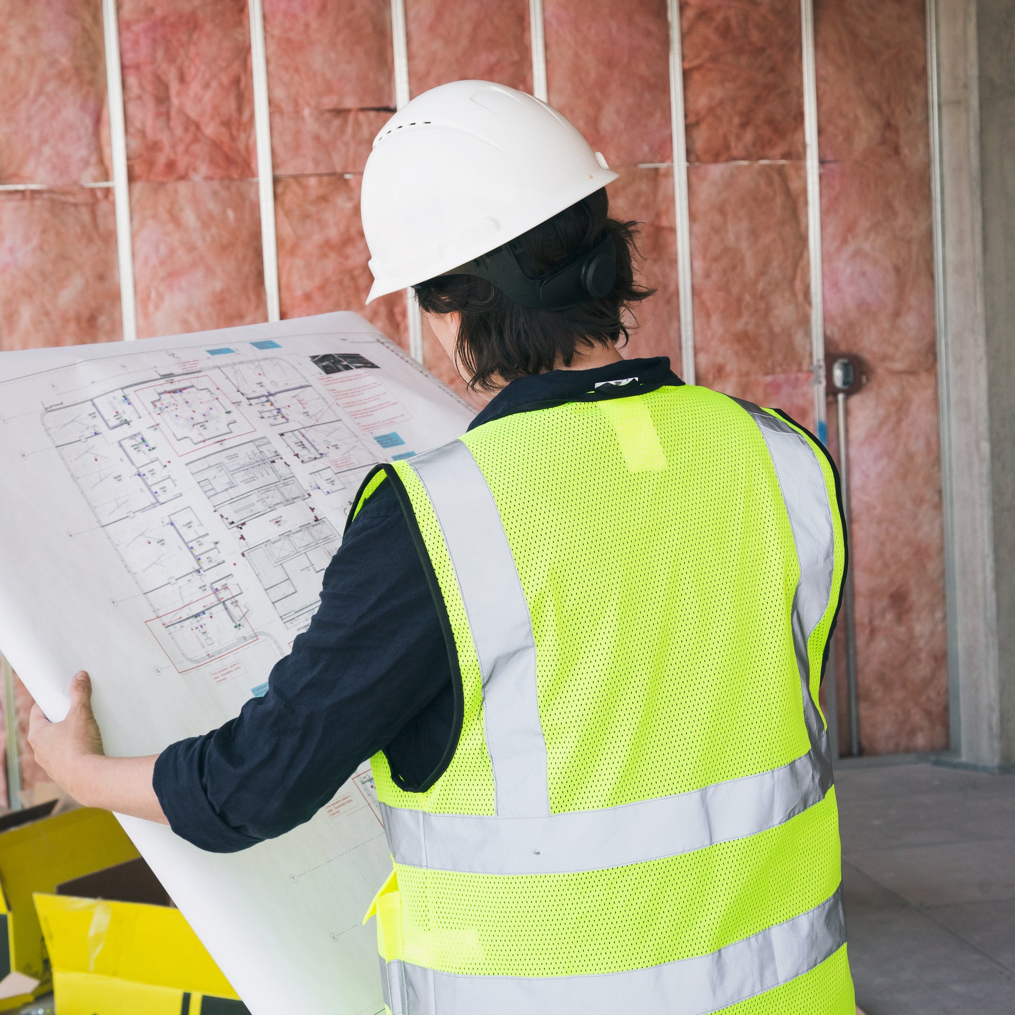 construction worker holding blueprints