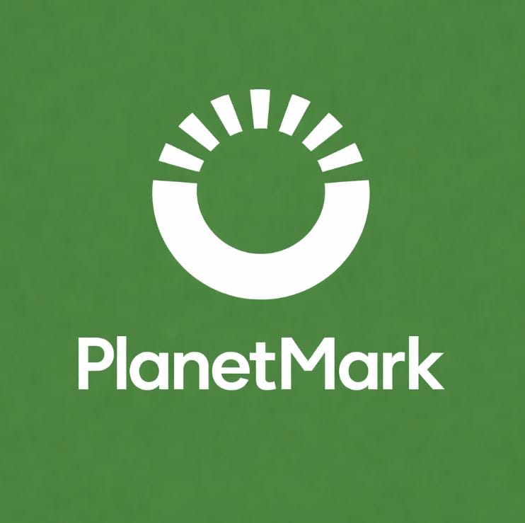 White 'PlanetMark' logo on a green background