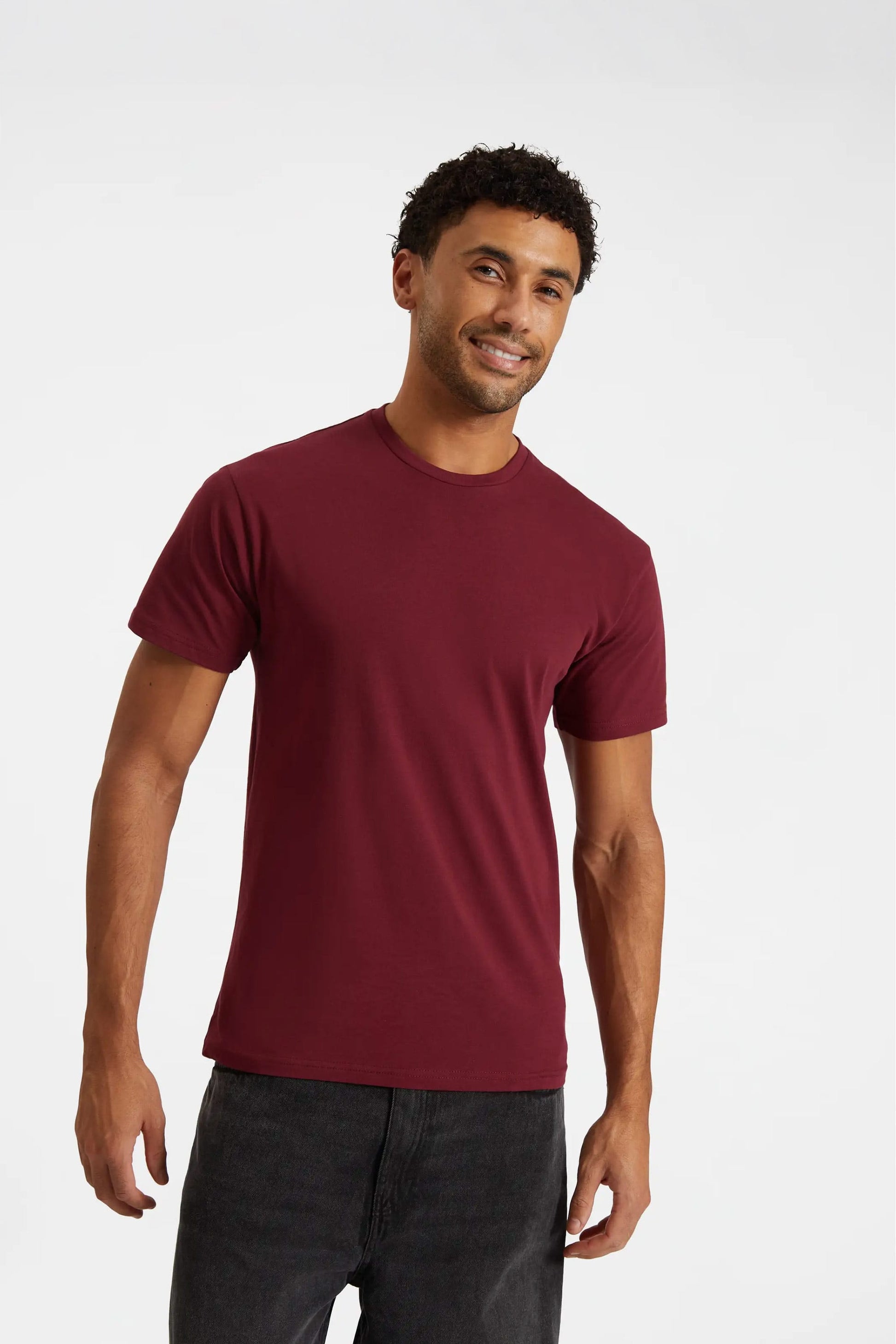Man wearing a maroon t-shirt on a white background