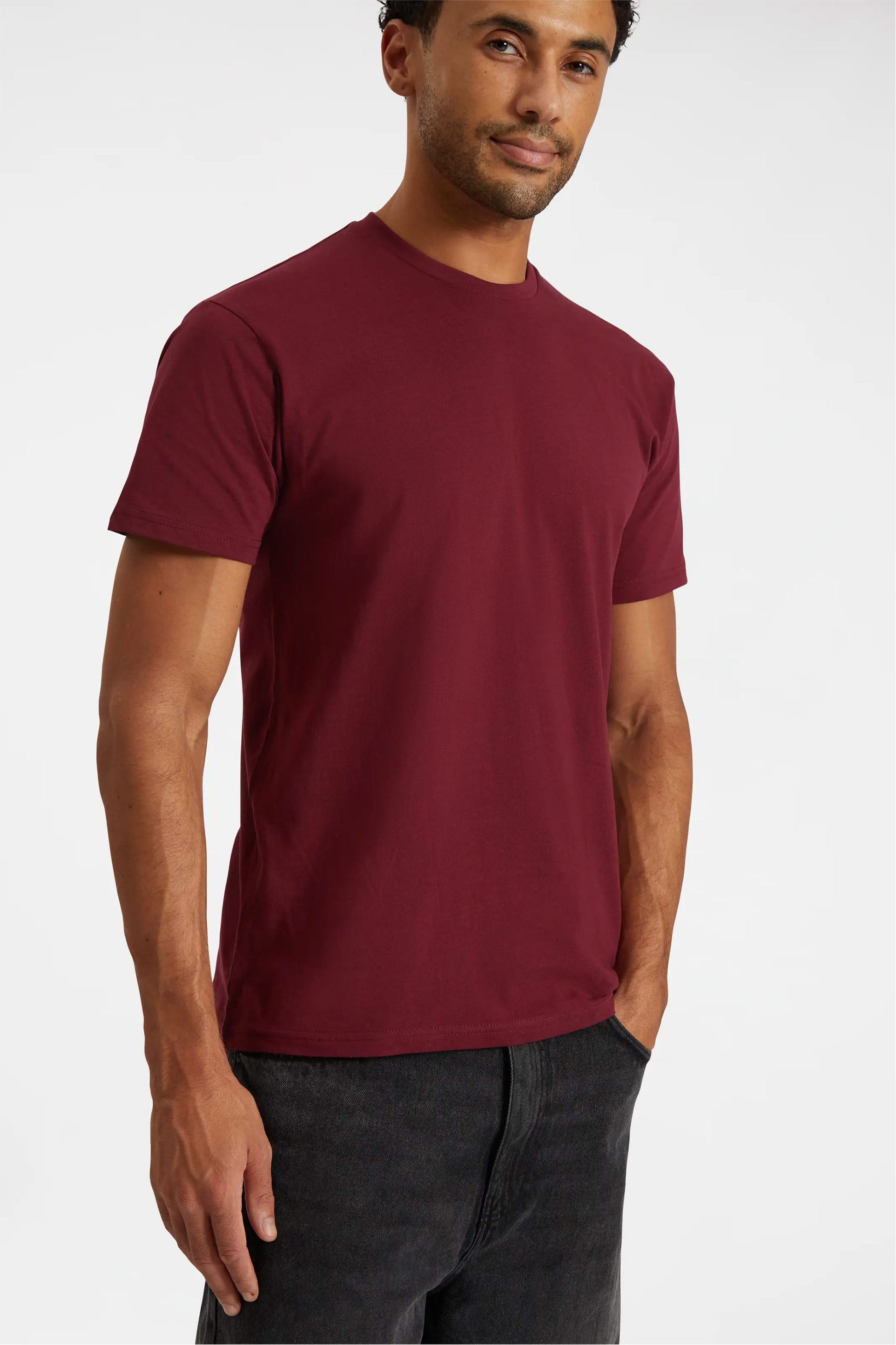Man wearing a maroon t-shirt on a white background
