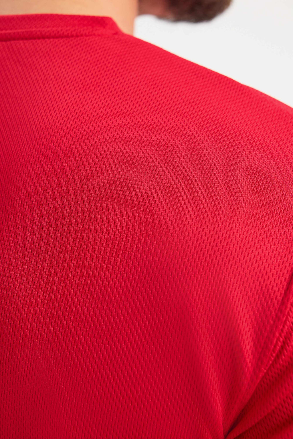 Close-up of a red textured shirt on a white background