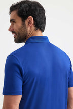 Man wearing a blue polo shirt on a white background