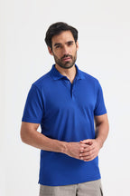 Man wearing a blue polo shirt against a white background