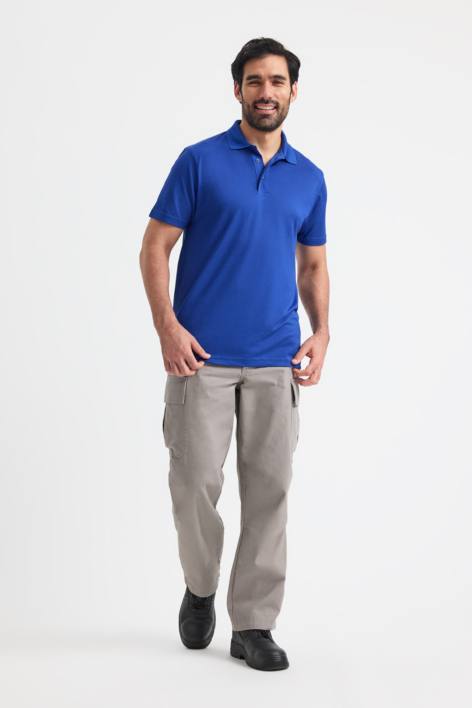 Man wearing a blue polo shirt and grey pants on a white background