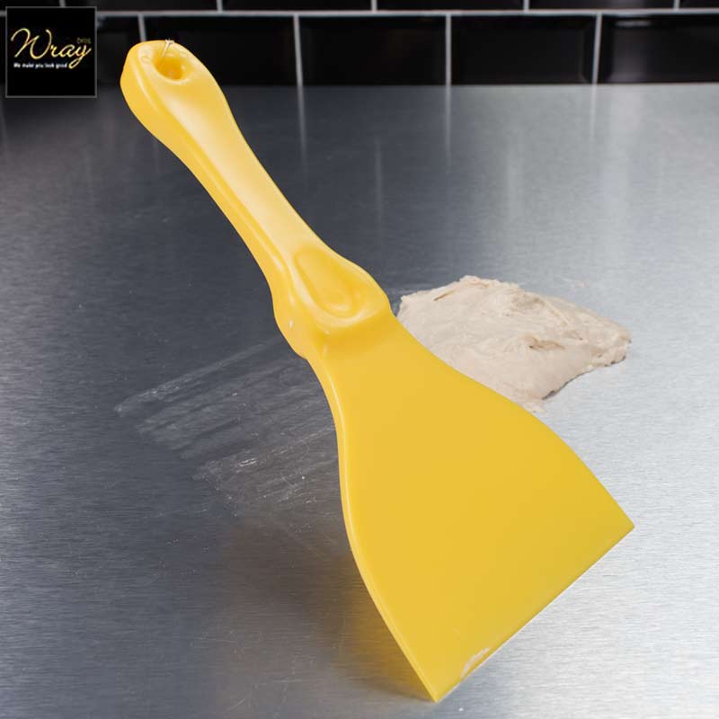 yellow plastic hand scraper